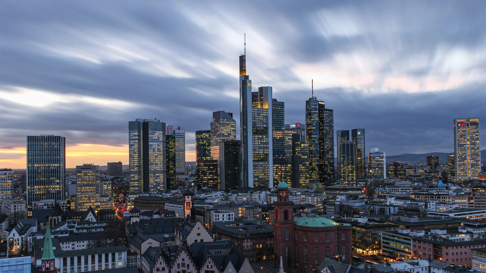 The Frankfurt skyline at dusk, with the old town and St Paul’s Church in front of it.